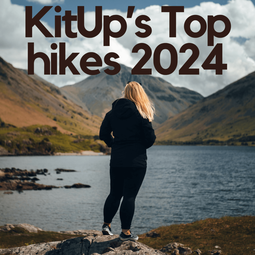 A woman standing at the bottom of Scafell Pike, the highest point in England, looking across the water at the mountain.